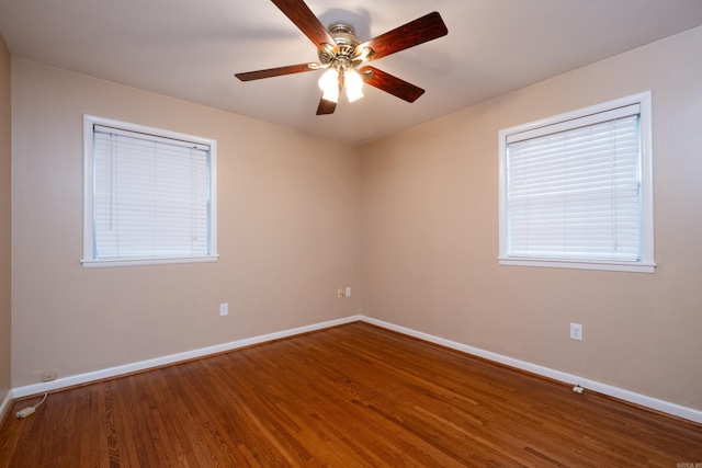 spare room featuring hardwood / wood-style floors, plenty of natural light, and ceiling fan