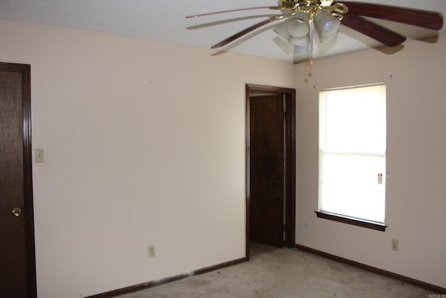 spare room featuring light colored carpet