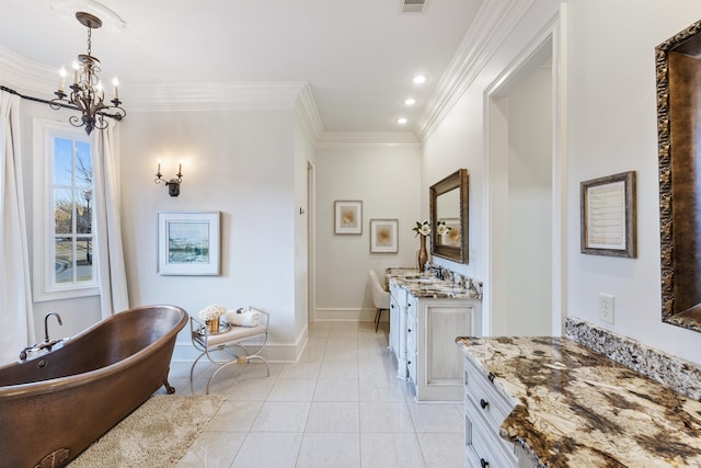 bathroom featuring an inviting chandelier, tile patterned flooring, crown molding, a bathtub, and vanity