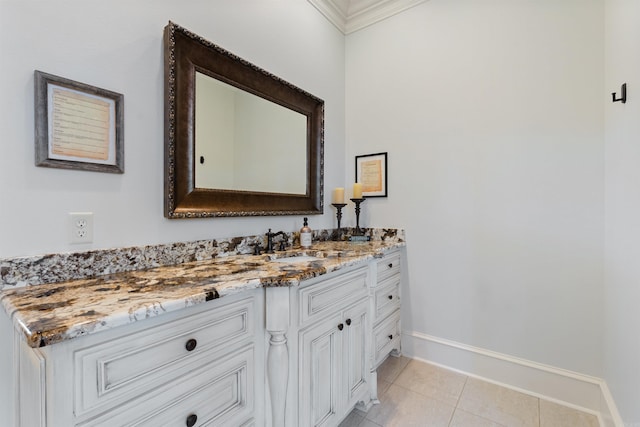 bathroom with tile patterned floors, crown molding, and vanity