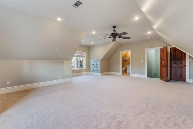 additional living space featuring ceiling fan, light colored carpet, and lofted ceiling