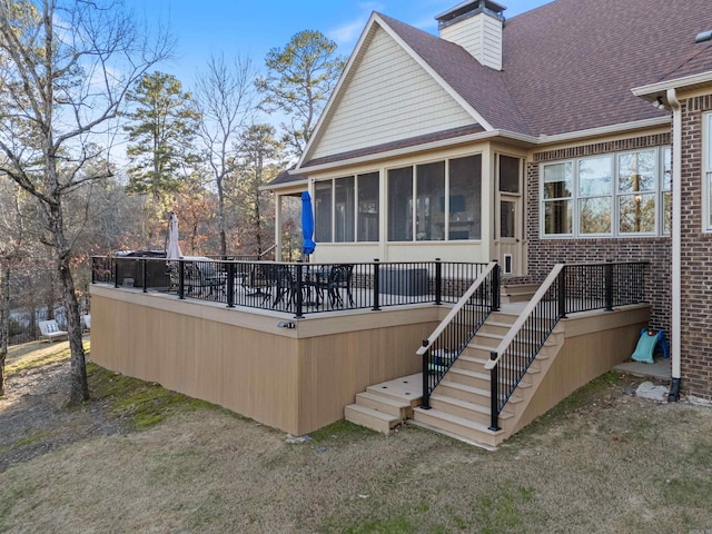 rear view of property featuring a sunroom