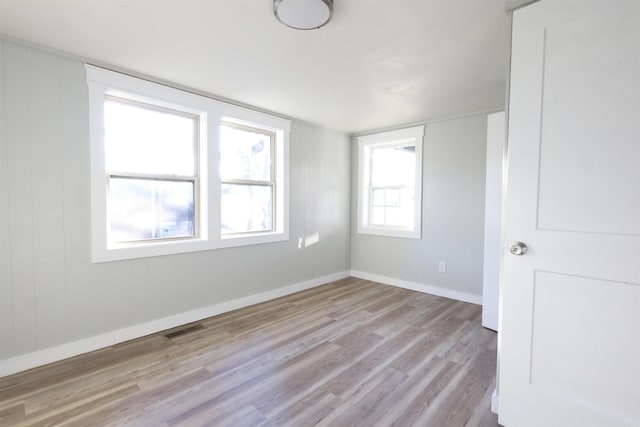 empty room with light hardwood / wood-style flooring