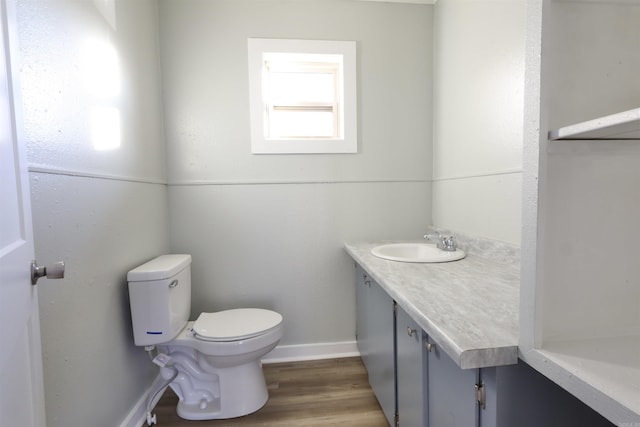 bathroom featuring hardwood / wood-style floors, vanity, and toilet