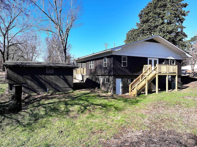 rear view of house featuring a deck and a yard