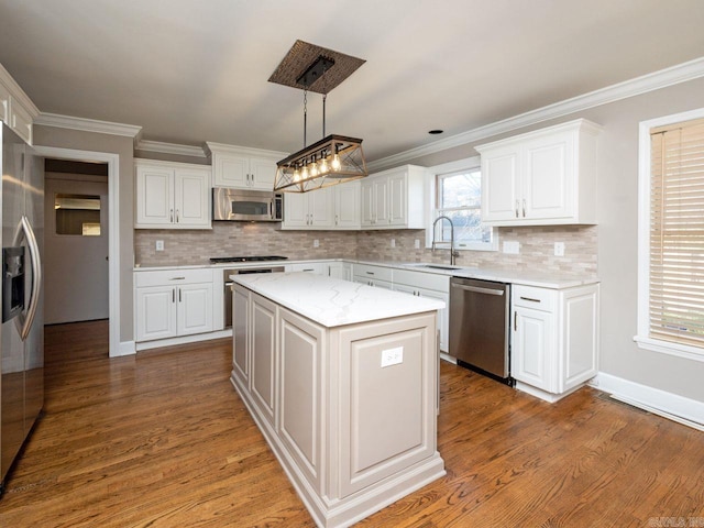 kitchen featuring sink, a kitchen island, pendant lighting, white cabinets, and appliances with stainless steel finishes