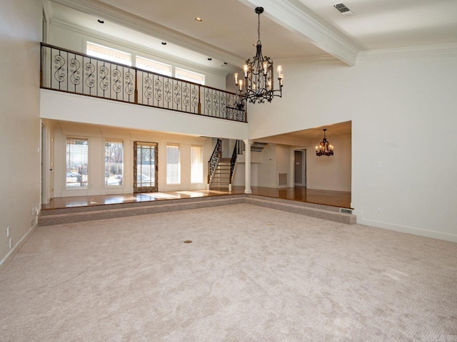 unfurnished living room featuring a high ceiling, carpet flooring, ornamental molding, beamed ceiling, and a chandelier