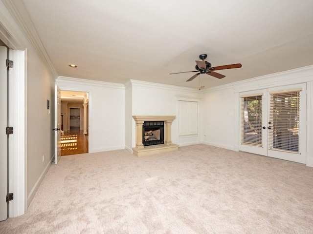 unfurnished living room with french doors, light colored carpet, ceiling fan, and crown molding