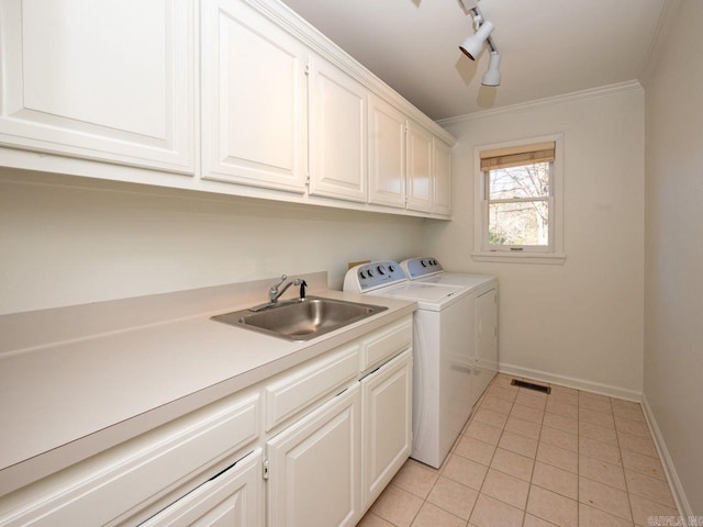 washroom featuring sink, cabinets, track lighting, washer and clothes dryer, and light tile patterned flooring