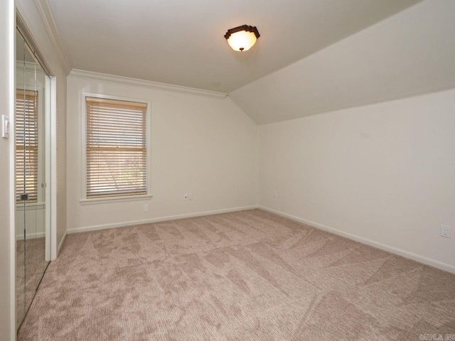 bonus room featuring light colored carpet and lofted ceiling