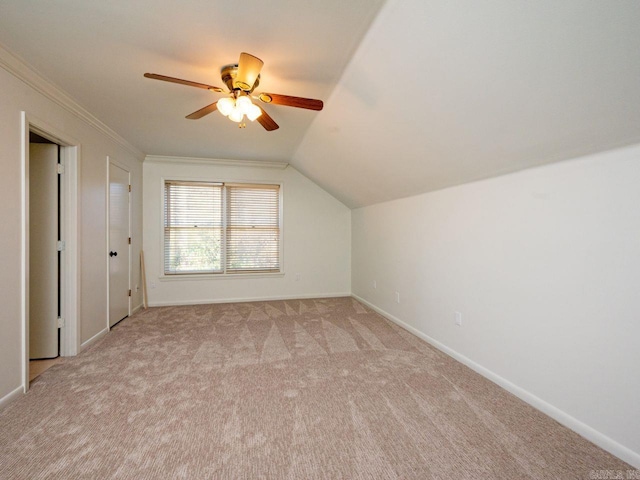 additional living space featuring light carpet, ceiling fan, and vaulted ceiling