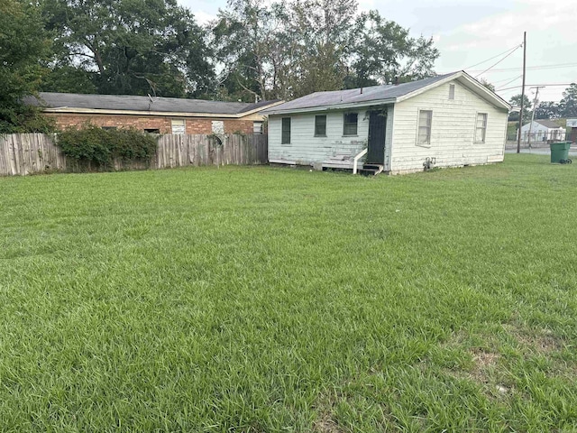 back of house with a lawn