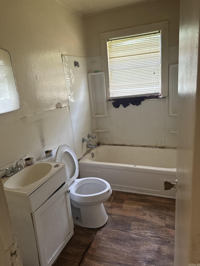 full bathroom featuring hardwood / wood-style floors, vanity, shower / bath combination, and toilet