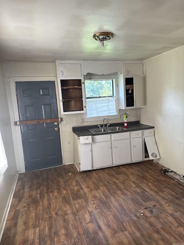 kitchen featuring dark hardwood / wood-style flooring, white cabinetry, and sink