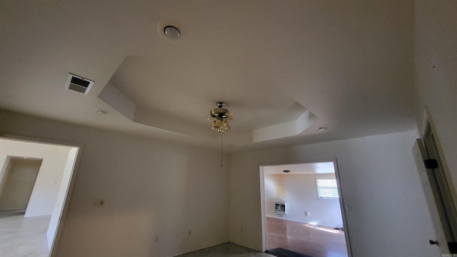 unfurnished room with a raised ceiling