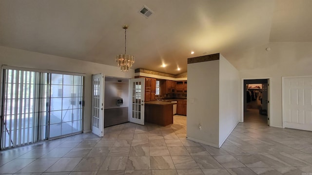 kitchen featuring vaulted ceiling, french doors, decorative light fixtures, and a notable chandelier