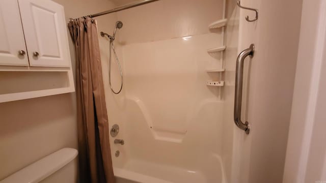 bathroom with shower / bath combo and toilet