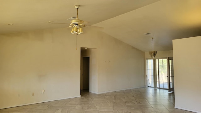 spare room with ceiling fan with notable chandelier and lofted ceiling