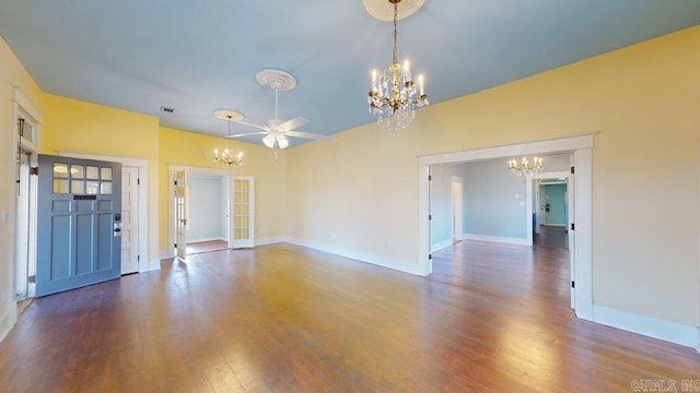 unfurnished living room featuring french doors, dark hardwood / wood-style flooring, and ceiling fan with notable chandelier