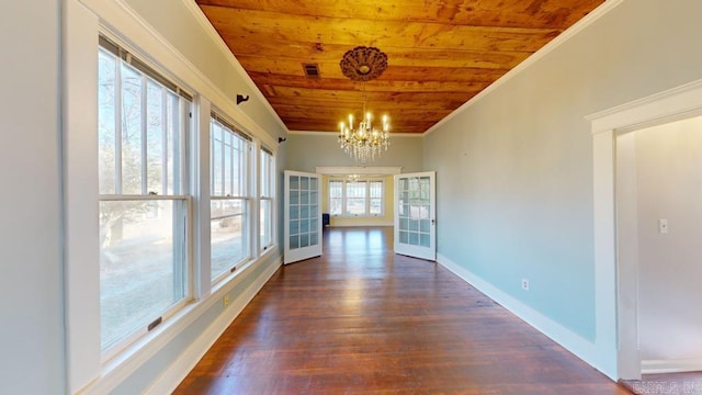 unfurnished sunroom featuring french doors, wood ceiling, and a notable chandelier