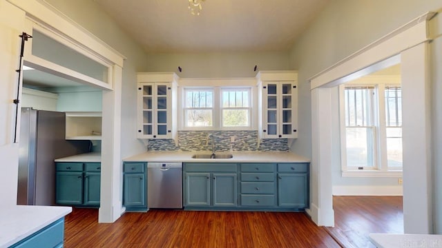 kitchen with white cabinetry, dishwasher, sink, dark wood-type flooring, and tasteful backsplash