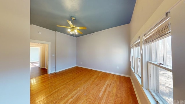 unfurnished room with ceiling fan and light wood-type flooring