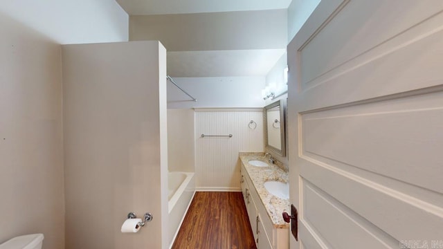 full bathroom featuring hardwood / wood-style floors, vanity,  shower combination, and toilet