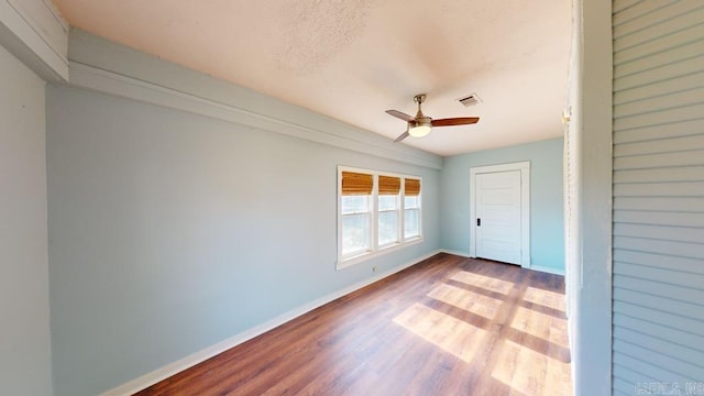 spare room featuring light wood-type flooring and ceiling fan