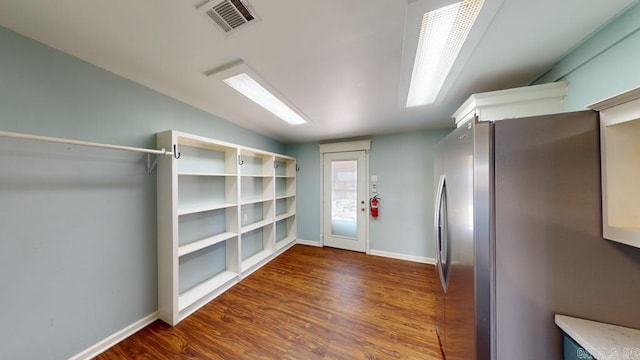 kitchen featuring stainless steel fridge and dark hardwood / wood-style floors