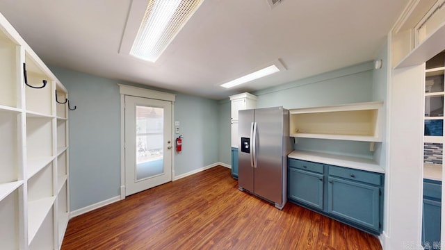 kitchen with dark hardwood / wood-style flooring, stainless steel fridge with ice dispenser, and blue cabinets