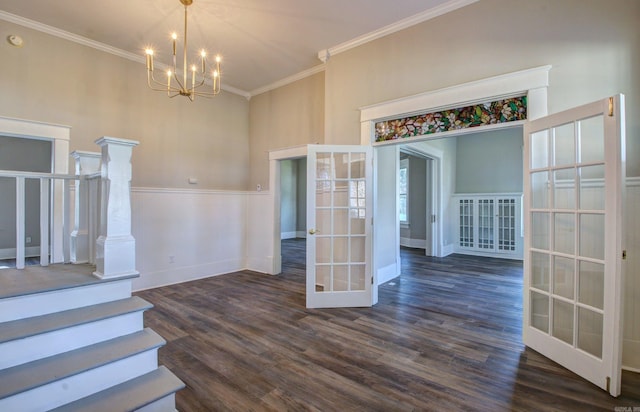 interior space featuring french doors, dark hardwood / wood-style flooring, an inviting chandelier, and ornamental molding