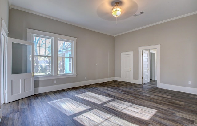 spare room with ceiling fan, crown molding, and dark wood-type flooring