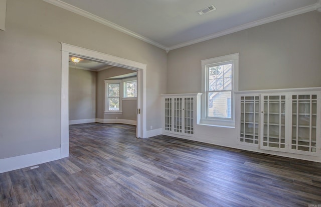 unfurnished room featuring dark wood-type flooring and ornamental molding