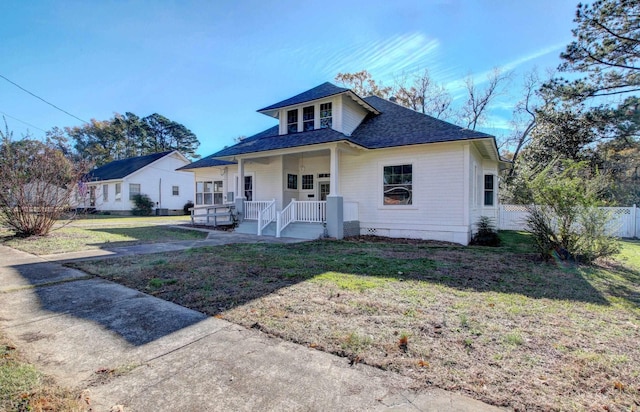 bungalow-style home with covered porch and a front lawn