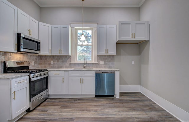 kitchen featuring white cabinetry, sink, light stone counters, and appliances with stainless steel finishes