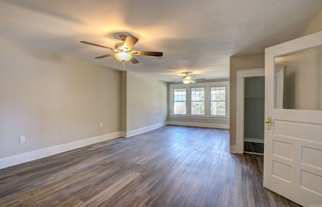 unfurnished room with ceiling fan and dark hardwood / wood-style floors