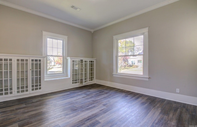 spare room featuring a healthy amount of sunlight, dark hardwood / wood-style floors, and ornamental molding