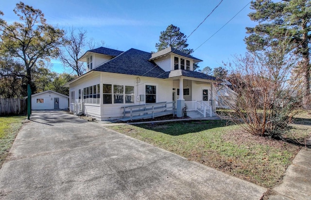 view of front of home with an outbuilding, a garage, and a front lawn