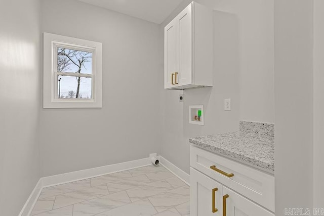 clothes washing area with hookup for an electric dryer, cabinets, and washer hookup