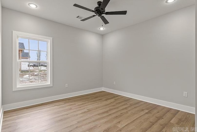 empty room featuring ceiling fan and light hardwood / wood-style floors