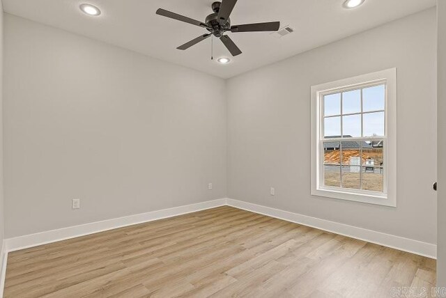 spare room featuring light hardwood / wood-style flooring and ceiling fan