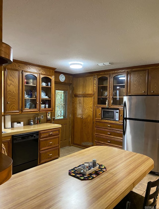 kitchen with a textured ceiling and stainless steel appliances