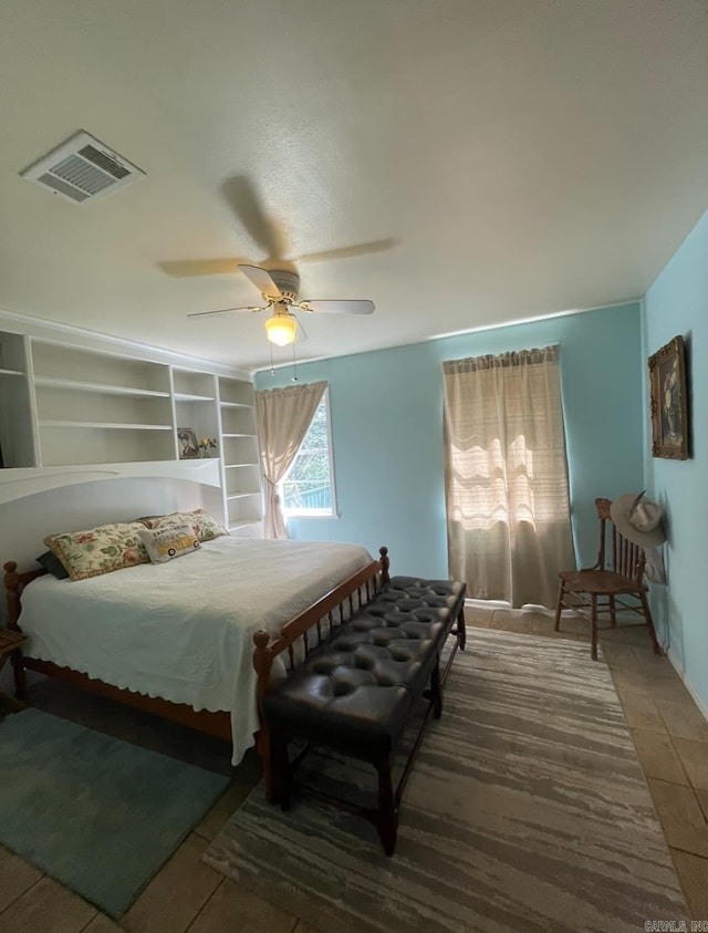 bedroom with ceiling fan and tile patterned flooring