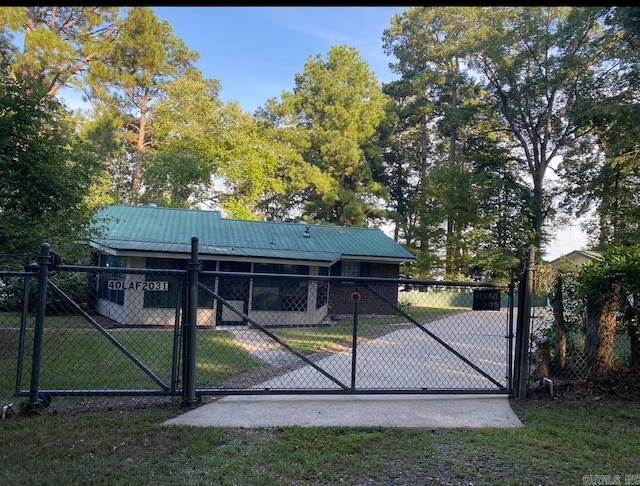 view of gate featuring a yard