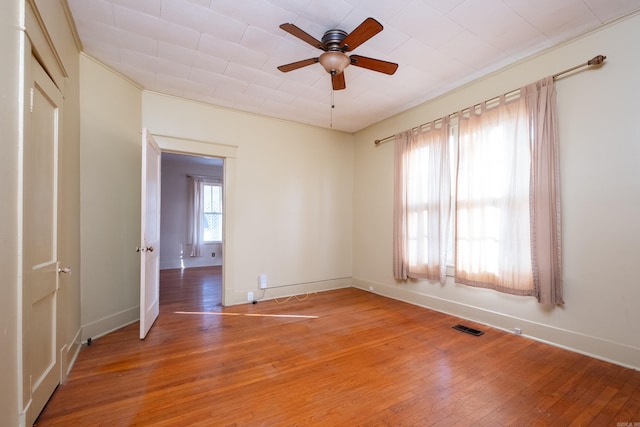 empty room with ceiling fan and wood-type flooring