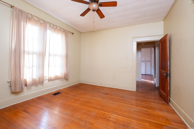 spare room with ceiling fan and light wood-type flooring