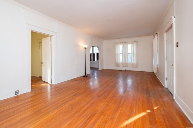 unfurnished living room with crown molding and light hardwood / wood-style flooring