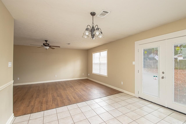 interior space with a textured ceiling and ceiling fan with notable chandelier