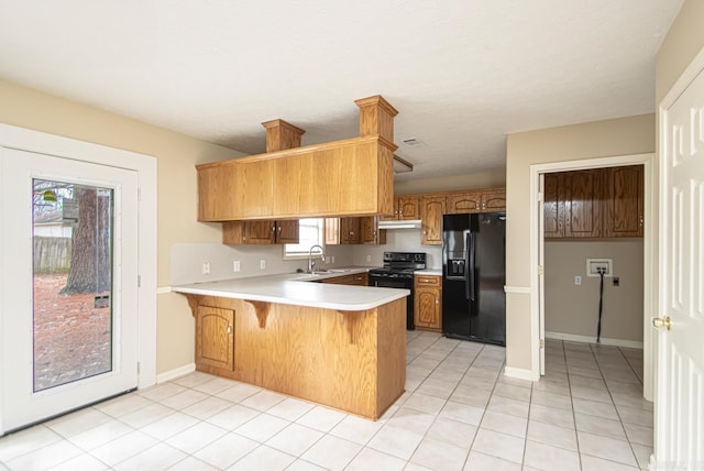 kitchen featuring kitchen peninsula, sink, a healthy amount of sunlight, and black appliances