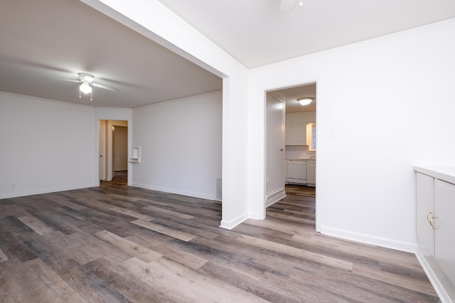 spare room with crown molding, ceiling fan, and dark hardwood / wood-style floors